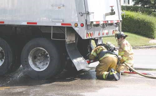 Firefighters work to extinguish a semi-trailer brake fire on York Road July 29. The heavy duty brakes on rigs are always susceptible to sticking and igniting, but hot weather in Yorkton last week did not help matters for the driver of the vehicle.