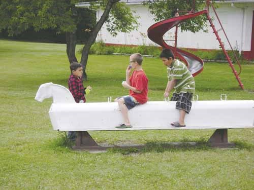 It&#8217;s summertime, and school is out, so youngsters in Yorkton are spending their time having fun. That means for some, time spent in one of several area parks where they can make use of the playground equipment on hand. Here a trio of youth use an old-fashioned rocking horse located at York Lake Regional Park.