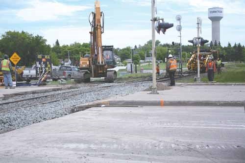 Railway workers remediate the tracks at Broadway between Myrtle and Maple Avenues. The work resulted in a detour for the better part of a day.