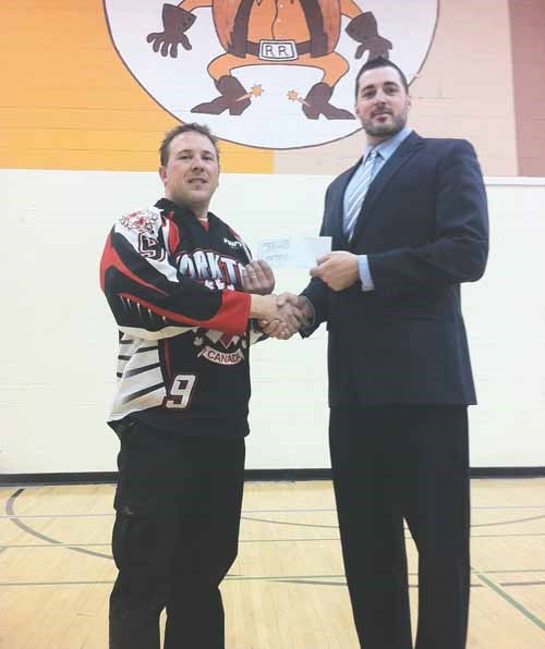 Lawrence Klamenski with the Kinsmen Club of Yorkton accepts a cheque from Brandon Needham vice principal at the YRHS for $1072.50.The money is raised by the staff to dress down on Friday&#8217;s.