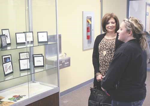 Angelina Kardynal, left, chats with a guest during the artist&#8217;s reception for her new art and graphic design exhibition at pARTners Gallery at Yorkton Public Library March 15. It is her first art show. See related local news story "Local artist launches first show"