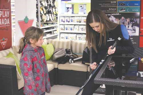Young Yorkton area curler Katelyn Farquharson has her curling broom signed by Olympic Gold Medalist Kaitlyn Lawes during an autograph session held at Canadian Tire in Yorkton on Monday evening. See related story.