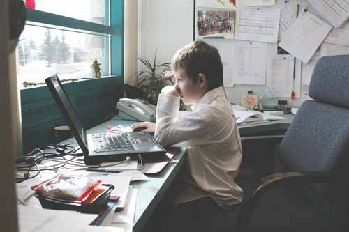 MC Knoll Grade 3 student Zachary Franklin answers emails in  the principal&#8217;s office at the school as part of his duties as principal for the day. Franklin chose the honour from a number of available prizes when his name was pulled in a raffle. Students earned raffle tickets by fundraising Free the Children to build a school in Haiti. See related story.