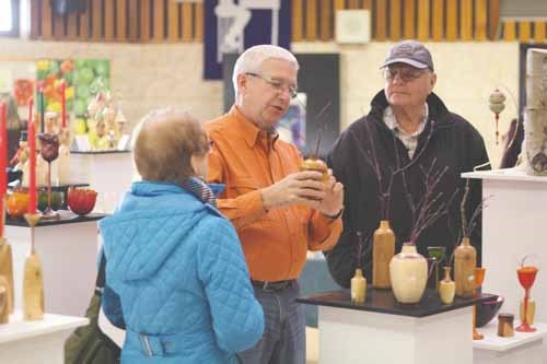 Jim Logan explains his turned wood creations to a pair of prospective customers at the Three Wise Women Gift Market December 7 at Yorkdale Student Centre. Logan was a newcomer to the 14th annual event started by Sandra MacColl, a former Yorkdale teacher, and two friends who have since moved away. The idea behind the sale is to support local artists and artisans. It&#8217;s an invitational event with all of the participants having some connection to MacColl or her family.