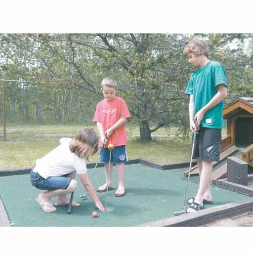 May long weekend at Good Spirit Lake was a cool one, but the Davies family enjoyed a round of putt putt golf on a sunny Victoria Day. Left to right: Avia; Dawson; Dryden.