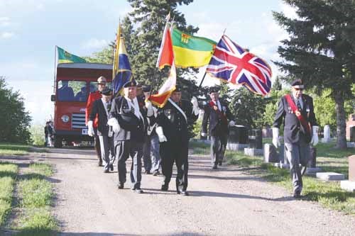 Veterans parade through the city cemetery June 6 to commemorate D-Day, the landing of Allied Forces at Normandy on June 6, 1944.