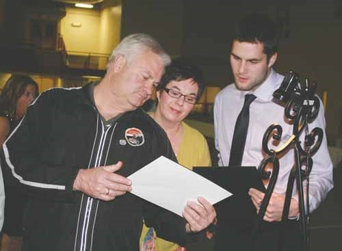 The Yorkton Terriers held their annual award&#8217;s banquet Friday at the Nexera Flexihall in the city  (see related story on web). Here graduating Terrier defenceman John Niebrandt, right, and his parents Brian and Cheryl take a closer look at one of the team photographs.
