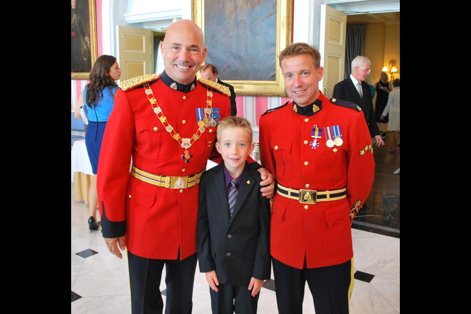 Burnaby Staff Sgt. Andy LeClair, right, with his son Ben, centre, and RCMP Commissioner Bob Paulson at an award ceremony on Sept. 9 where LeClair received the Order of Merit of the Police Forces.