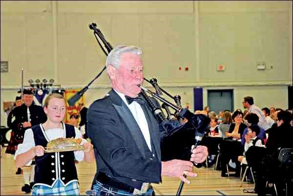 Local piper Jim Ramsay and Battlefords Highland Dance Association dancer Mishele Tady bring in the haggis at the annually sold-out Robbie Burns Night at the Alex Dillabough Centre in Battleford Saturday.