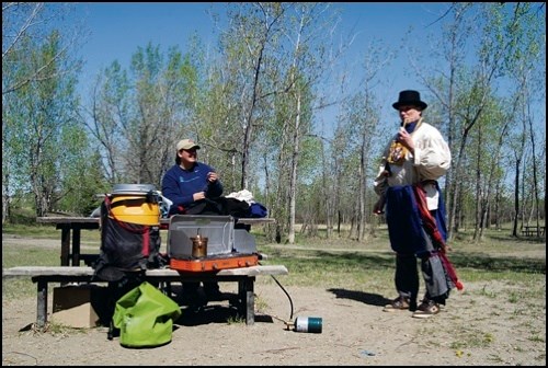 As part of Tourism Week in the Battlefords, Battlefords Tourism had intended to host a Voyageur canoe ride around Finlayson Island. Cool, windy weather kept interested individuals at home, but Vinessa Currie-Foster of Clearwater Canoeing still put on a demonstration for those who turned out. She dressed Owen Einsiedler, field representative for Tourism Saskatchewan, up as a voyageur from around the turn of the 19th century, taking care to describe every clothing item and its purpose.