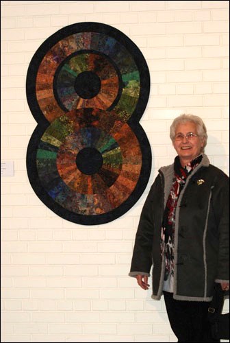 Rivers&#8217; Edge Quilters member Jeannine Ferguson with her piece, Circle of Friends. She was one of 14 original members of the club that formed in 2000. There are now nearly 40 active members.