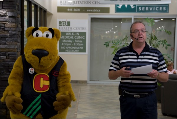 Cooper, the Co-Op mascot and Pat Smith, Battlefords and District Co-op General manager, kicking off a day of celebrations of the organization&#8217;s eightieth anniversary. Attendees were fed with a pancake breakfast and free cake, entertained with a kid&#8217;s carnival, Leon Ochs playing music and some activities from the WDM and were visited by the Battlefords North Stars prior to their home season opener. It is estimated that over 800 people took part in the activities.