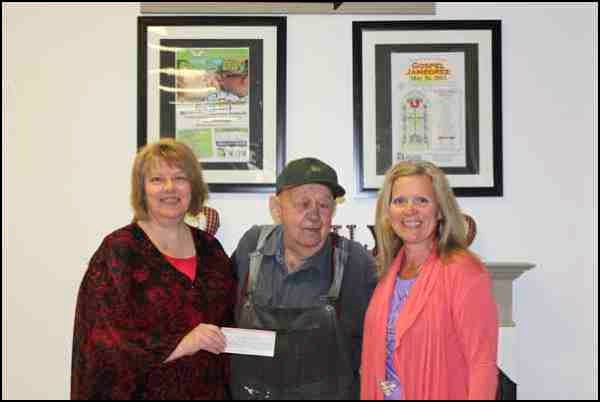 Edwin Wells, a long-time volunteer at the Western Development Museum, presents a cheque to museum manager Joyce Smith, and programs and volunteer co-ordinator Cheryl Stewart. His donation will be put towards the restoration of the doctor's home in the Heritage Farm and Village. The home once belonged to one of North Battleford's first doctors, Quebec-born Dr. Joseph Jules Hamelin. Filled with furnishings and artifacts donated by the French Canadian community, the building is fondly referred to as the &#8220;French House." If you would like to donate to help with the much needed restorations, please contact the WDM at 306-445-8033.