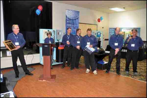 Howard Kirby of Anderson Pump House was honoured at the company&#8217;s 30th anniversary trade show at the Gold Ridge Centre Thursday. Staffers gathered at the front of the room to hand Kirby a plaque and roll out a celebratory cake to commemorate 30 years of the operation. The presentation was made before a full audience at the trade show, including dignitariessucy  as North Battleford mayor Ian Hamilton and Battleford mayor Derek Mahon.