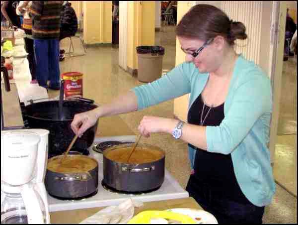 Le Centre Francophone des Battleford annual Carnaval d'Hiver was held Friday, March 1 at the Don Ross Centre. A pot luck supper, skating, sledding and taffy-eating were on the agenda.  Gabrielle Desnoyers does double duty as she stirs the maple syrup for "taffy on the snow."