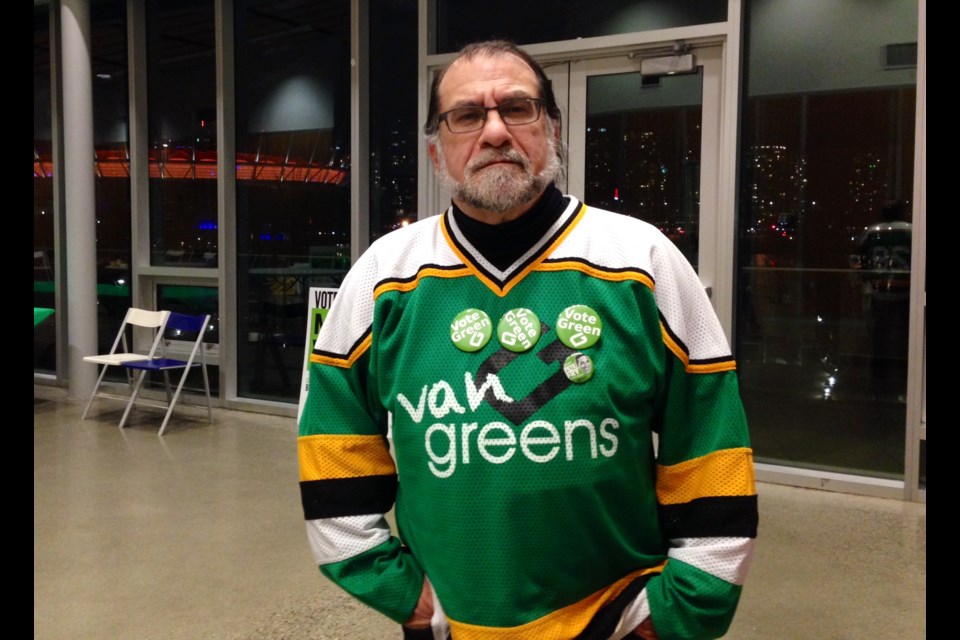 Sid Hayes, a Green Party volunteer, wore a colour-appropriate campaign jersey on voting day. He arrived early at the Creekside community centre before polls closed Nov. 15, 2014.