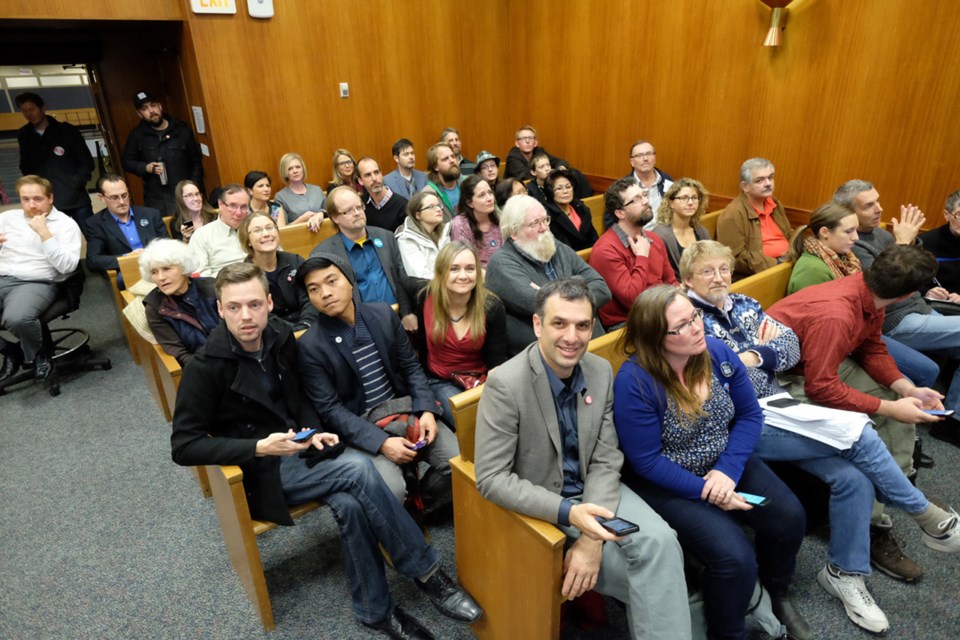 Candidates, supporters and interested onlookers watch the results come in at New Westminster City Hall.