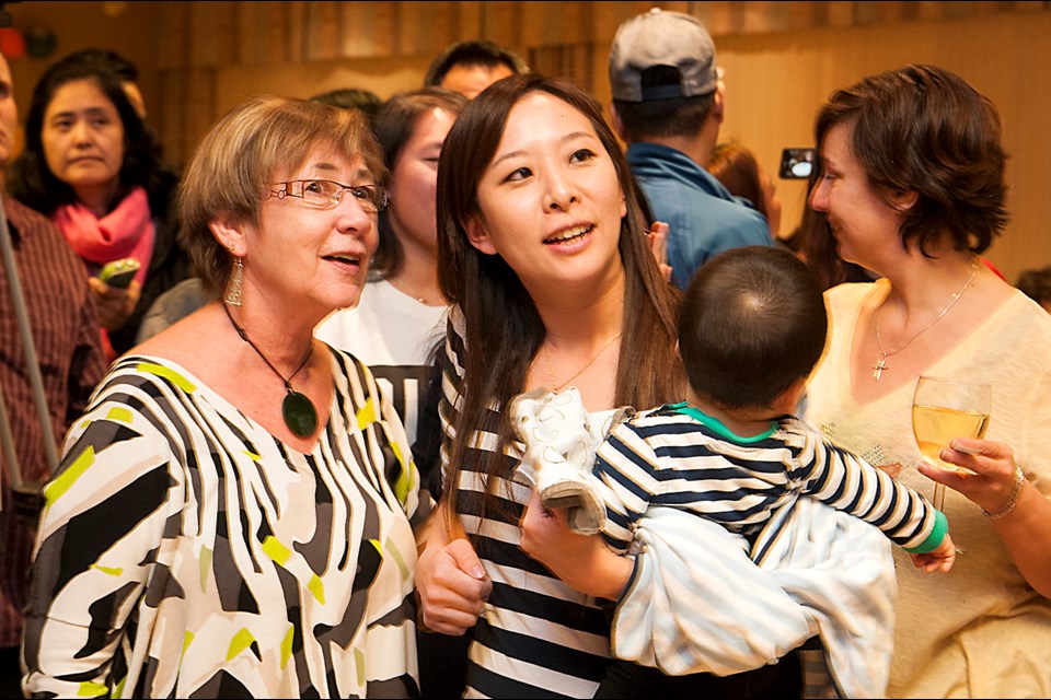 Burnaby Citizens Association trustee-elect Katrina Chen watches election results at her party's headquarters Saturday.