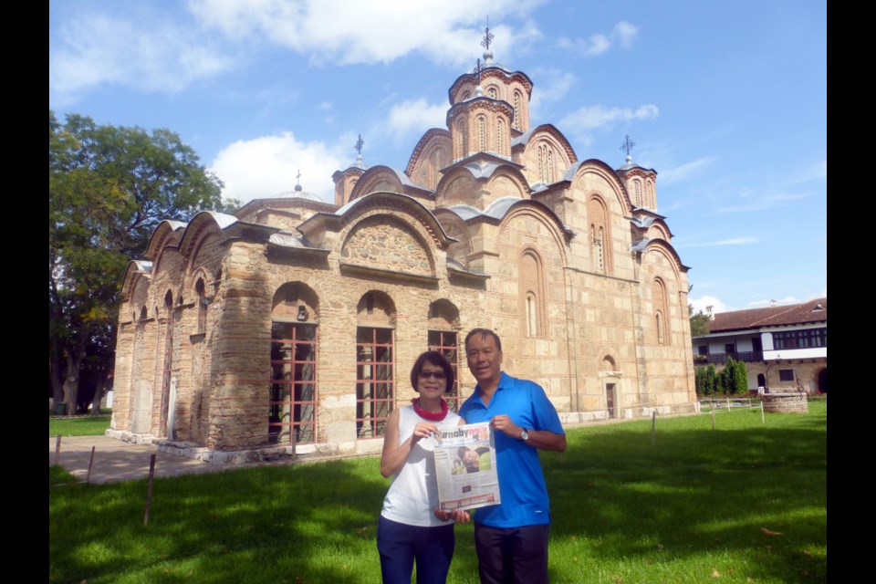 Tom and Susana Wong in front of the Gracanica Monastery in Pristina, Kosovo.
