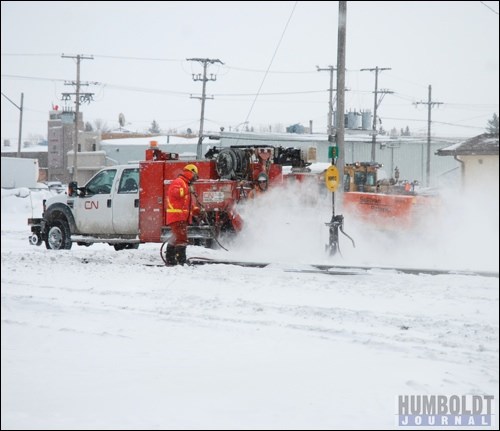 A CN Rail crew was cleaning snow and ice off the tracks just west of the Main St. crossing in Humboldt just prior to the snowfall warning&#8217;s end.