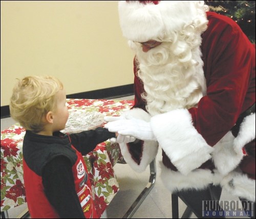 Quinn Frederick of Watson didn&#8217;t hesitate to shake Santa&#8217;s hand when he met him at the CIBC in Watson on November 30, one of the kick-off events for Santa Claus Days in Watson.