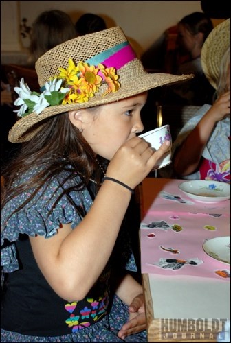 A young lady enjoys her cup of tea &#8212; pinky up &#8212; during the annual Victorian Tea Party.