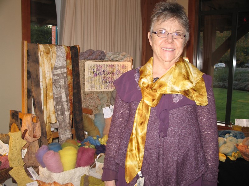 Ann Harmer, president of the Spinners and Weavers Guild, shows a scarf patterned with mushroom dyes.