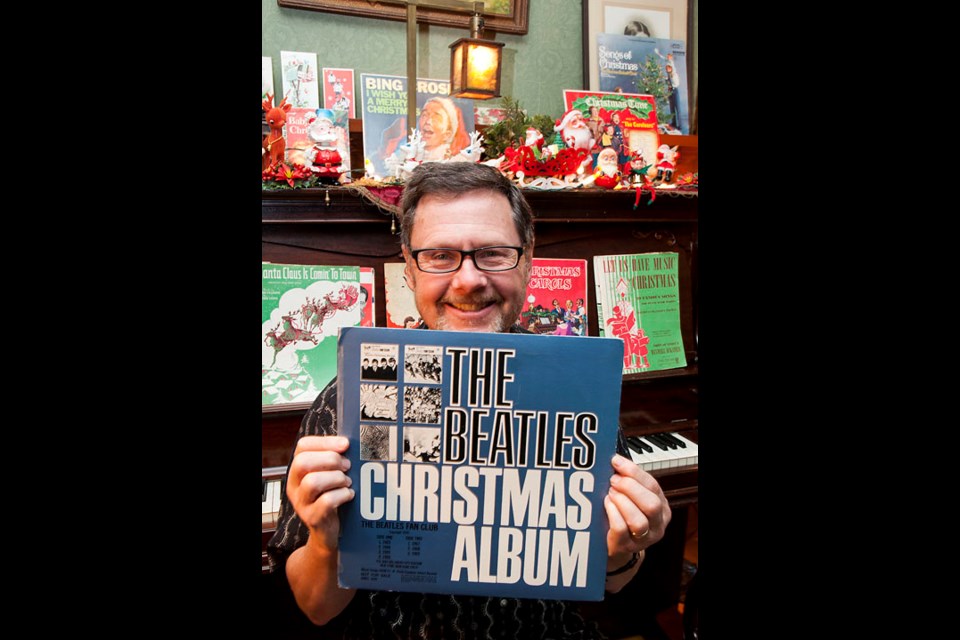 Blast from the past: Jim Hutson shows off one of the vintage Christmas records he's amassed through the years. Along with checking out the Hutson's vintage Christmas decor on the Homes for the Holidays tours, guests will also hear vintage records playing.