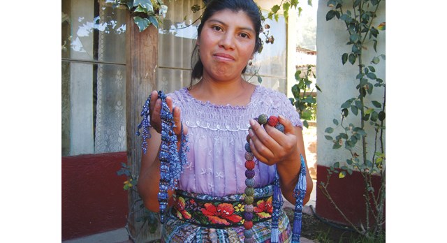 One of the Guatemalan widows shows off her creations