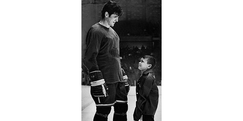A young Bobby Whitty stares up at Pat Quinn after being plucked from the stands at a Vancouver Canucks practice in 1970