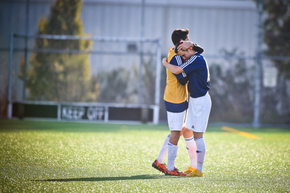 Sutherland co-captains Travis Ladhar and Dzenan Bezdrob console each other after losing the senior boys provincial AAA soccer final 3-0 against Panorama Ridge Saturday in Burnaby. Sutherland, a AA-size school, went on a surprise run over the past two seasons, winning last year's AAA title before claiming silver this season.