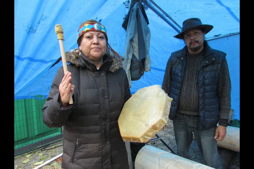 Sut-Lut with her brother Mike Antone, who is carving two protector poles for Burnaby Mountain.