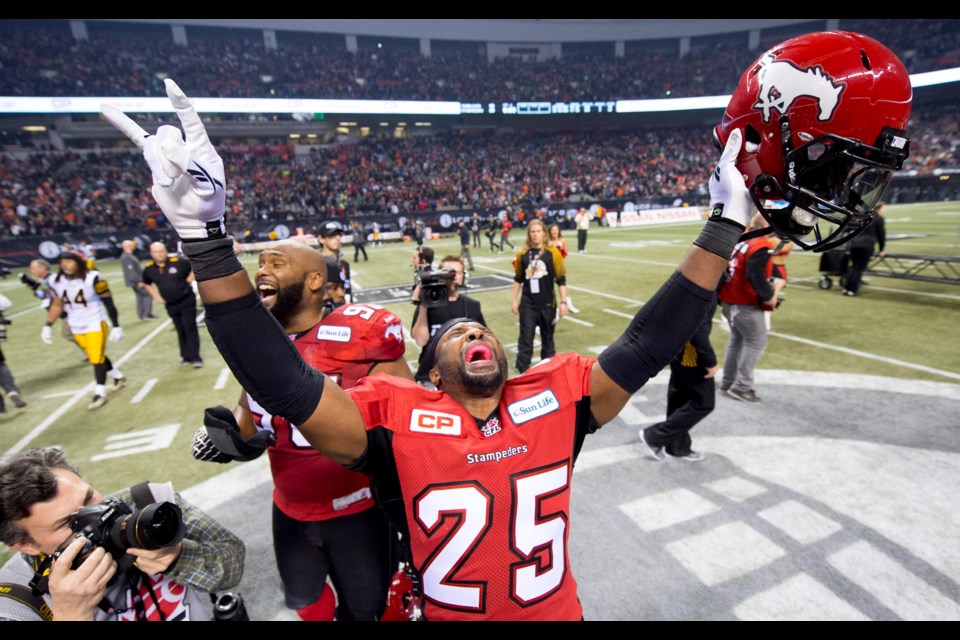 Calgary Stampeders defensive back Keon Raymond celebrates his teams win against the Hamilton Tiger-Cats during the 102nd Grey Cup in Vancouver, B.C. Sunday, Nov. 30, 2014. THE CANADIAN PRESS/Nathan Denette
