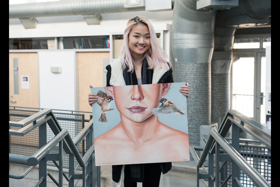 Emily Carr University of Art and Design student Tina Yan shows off one of her sold pieces at the school’s Student Art Sale held this past Friday through Sunday. Despite her painting talents, Yan is studying design. “I’ve been having a lot of, I would say, good luck in presenting my work and having people find it,” she said.