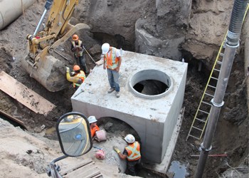 It&#8217;s an inconvenience for many, however it&#8217;s a necessary project and one that will take a little longer than expected the city reports. The crossing at York Road and Dracup Avenue has proven extremely challenging, involving three different utilities as well as replacing seven manholes and associated underground access vaults says Josh Mickleborough, Manager of Engineering and York Road/Dracup Avenue Project Manager. &#8220;The vaults weigh up to 45,000 lbs. and utility location problems also meant the water line had to be relocated.   &#8220;Issues with replacing 100 year old water, sewer and storm systems, which all converge at this location, further complicated this difficult and time consuming process. As a result, York Road will remain closed to regular traffic until mid-September, weather permitting.  Detour routes will remain in effect until further notice. City representatives say they regret the inconvenience this necessary project is having for residents and businesses in the city, particularly those directly impacted by the closure. This new infrastructure is expected to last for the next 70 &#8211; 100 years. PIctured, 45,000 pound manhole vaults are put in place as part of the new underground infrastructure.