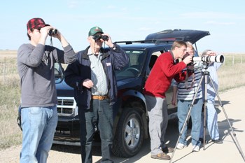 The field glasses and the bird guides were out on Tuesday, May 8 when approximately 35 members of The Yellowhead Flyway Birding Trail Association (YFBTA) accepted an invitation for some spring-migration bird watching and to become better acquainted new members. Pictured above (l-r) at the recent event are: Tanner Garbutt, YFBTA Summer Program Facilitator; George Murray, YFBTA director; Rob Wilson, YFBTA secretary; and Laurie, wife of George, and a member of the YFBTA. See more on Page 7. (Photo by Morley Maier.)