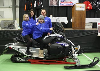 The 35th annual Snowarama might have been missing snow, but it still raised $105,033 for kids with disabilities. Snowarama Ambassador Bailey Clark (bottom right) and her family show off the big prize, a 2012 Yamaha Phazer GT.