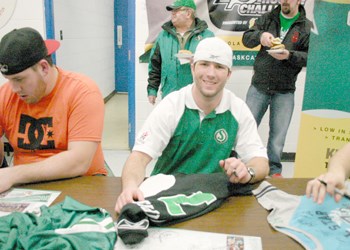 It wasn&#8217;t your typical afternoon rec. hockey game Saturday evening in Yorkton when a group of Saskatchewan Roughriders took on Yorkton Minor football coaches (and friends) in a fun match at the Kinsmen Arena. Proceeds raised through the event will help out with improvements at Kinsmen Century Field. While a good time was had by all, in the end the Roughriders defeated their challengers with a score of 10-3. Pictured above Rider Weston Dressler (#7) takes some time to sign autographs before the big game.
