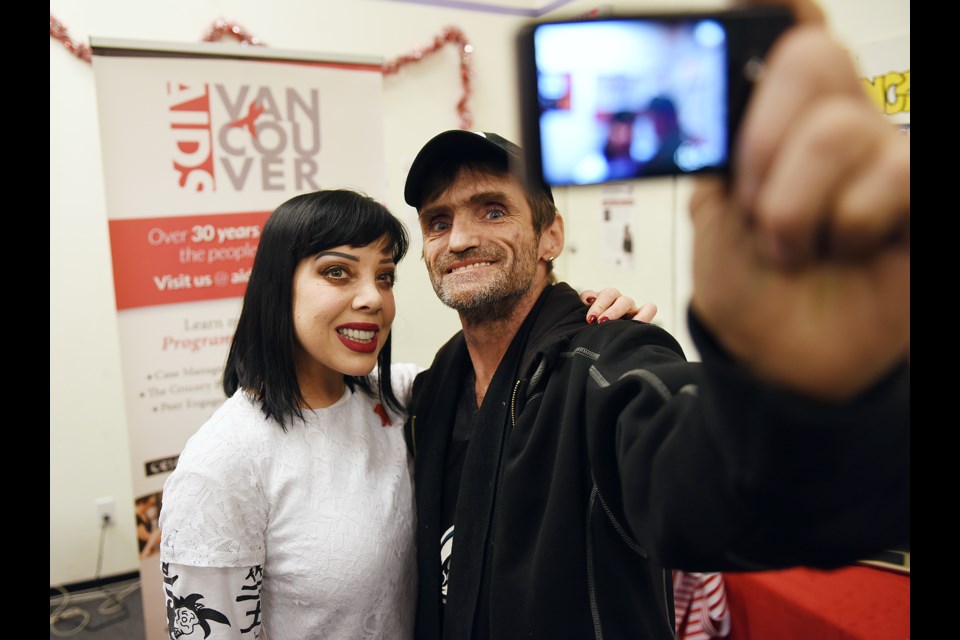 Musician Bif Naked poses for a “selfie” with Joe (JP) Smith at AIDS Vancouver food drive. photo Dan Toulgoet