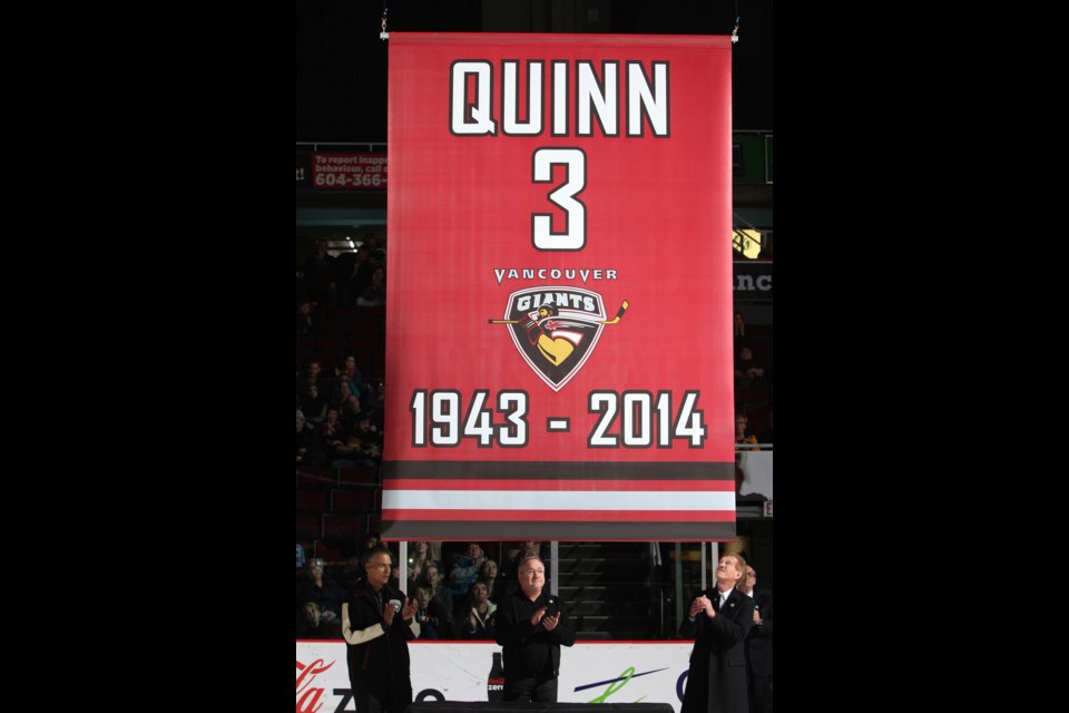 The Vancouver Giants paid tribute to late minority owner and former NHL player Pat Quinn by raising the number of the former NHL player to the rafters of at Pacific Coliseum on Dec. 5, 2014. Looking at the banner, from left to right, are Sultan Thiara, Ron Toigo and Lewis Buble.