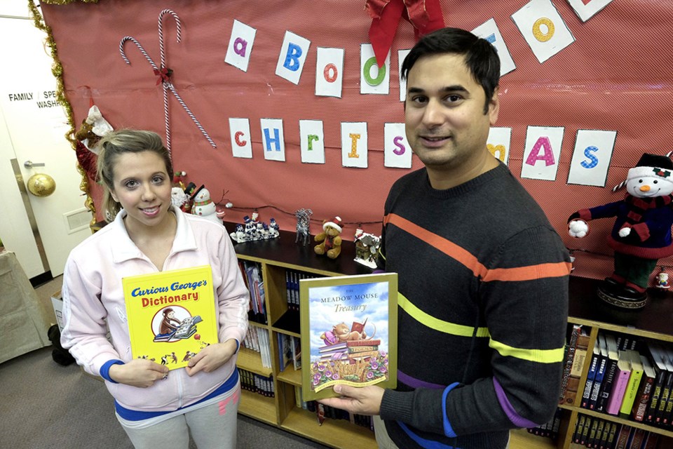 Stephen D'Souza, executive director of Burnaby Community Services, with volunteer Stephanie DiTomaso in the special book section set up in the Christmas Bureau's toy room. The bureau is expanding the book section and launching Books for Kids to help promote literacy in the community.