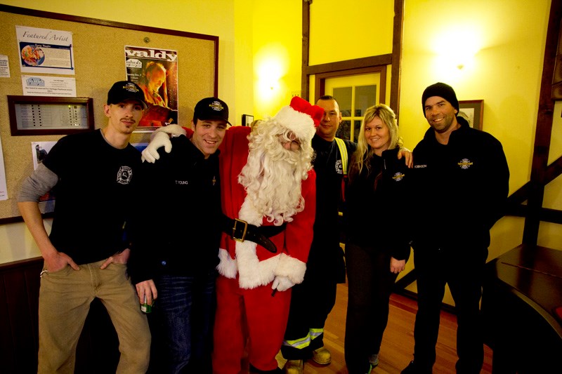 Firefighters Cody Robinson, Laren Bystedt, Fred Jurock, Travis Young and Tyna Bozak with Santa Claus.