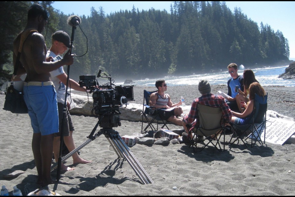 Director Rob Willey confers with Dark Cove cast members at Sombrio Beach last summer. Willey says the location proved difficult for shooting.