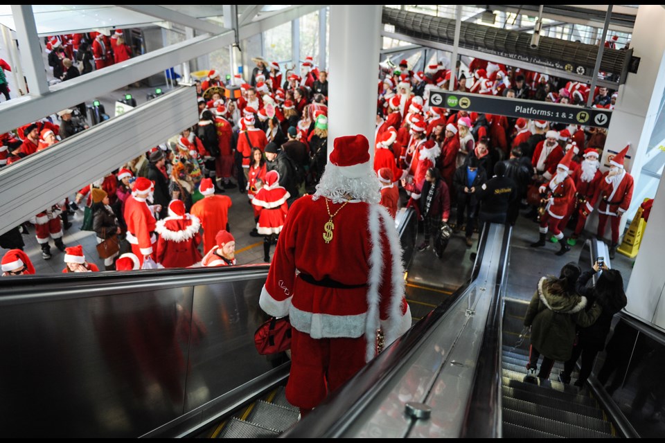 Vancouver’s annual SantaCon (or SantArchy ) took place Saturday. It is believed to be the 14th annual, but some remember small SantaCon events taking place in the late 1990s. Hundreds of people dressed in Santa’s outfit got together for drinks and to spread holiday cheer around the city. Photograph by: Rebecca Blissett