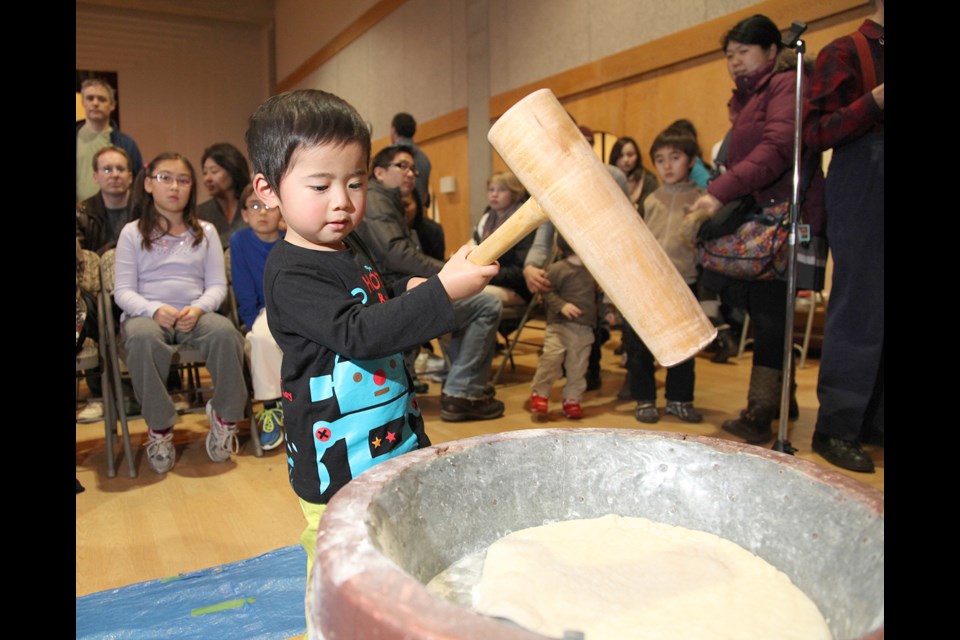 Cyan Reyes pounds mochi at the annual Mochitsuki Day at the Nikkei Centre in 2013. The annual end-of-year Japanese celebration runs on Dec. 29.