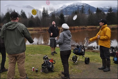 Competitors flip discs to determine partners during the doubles event on Sunday (Dec. 21). The two day disc golf event was the first of its kind in Squamish.