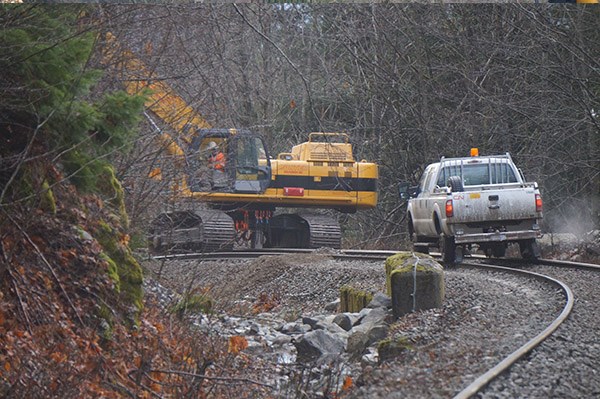 Off the rails: Canadian National Railway crews clean up after a Dec. 21 derailment near the Culliton Creek bridge, at the end of Paradise Valley Road. At least two train cars were flipped over.