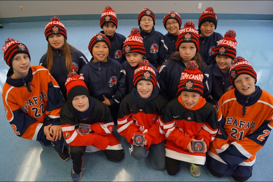 Photo: Seafair Atom A1 hockey players show off their fancy garb and special pucks for their upcoming tournament in Shanghai. Richmond, B.C. Dec. 27, 2014.