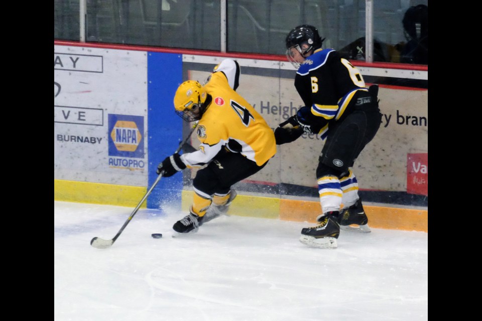 Gold medal hockey between Coq chiefs (yellow) and Langly Eagles ( black) at copeland arena
