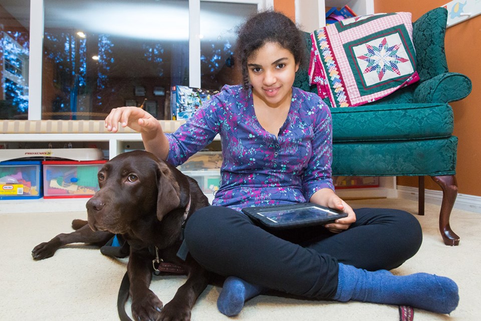 Maya Kaler, 13, with her support dog Pepe, a chocolate lab.